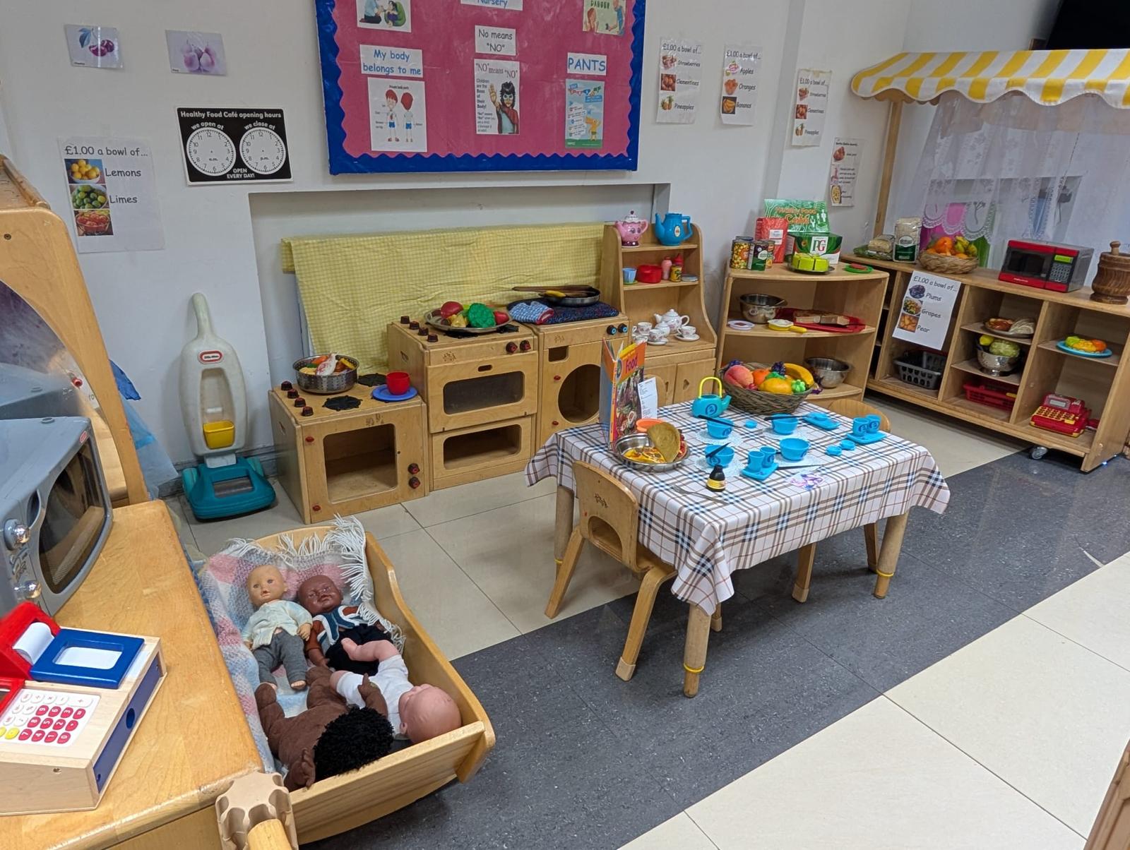 Baby care area with dolls and play kitchen